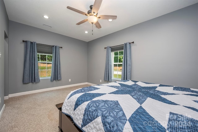 bedroom with multiple windows, carpet flooring, and ceiling fan