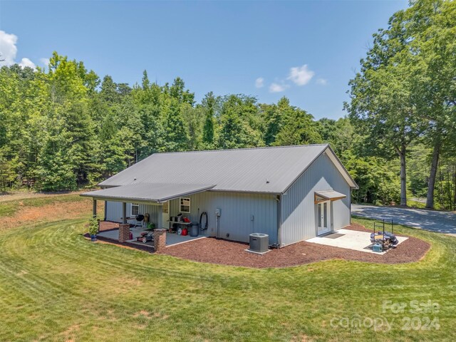 back of property featuring a lawn, a patio, and central AC unit