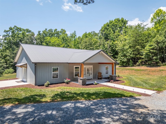 single story home with a front lawn and a porch