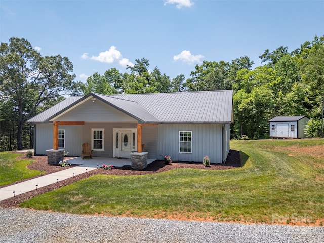 ranch-style house with a porch, a shed, and a front lawn