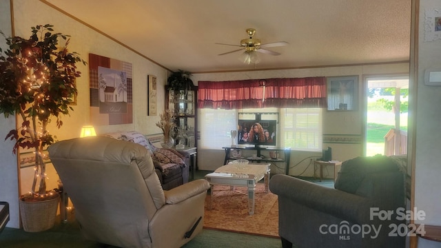 living room featuring ceiling fan, ornamental molding, a textured ceiling, and vaulted ceiling