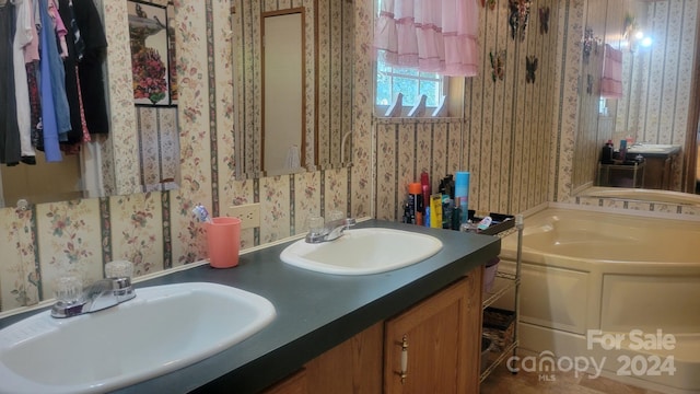 bathroom with a bath and vanity