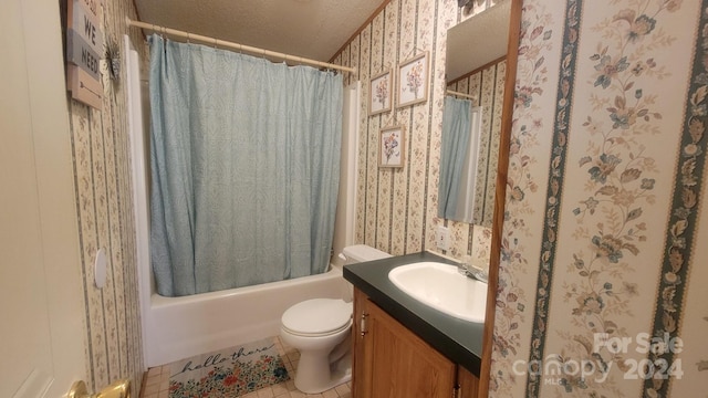 full bathroom with vanity, shower / bath combo with shower curtain, tile patterned flooring, toilet, and a textured ceiling