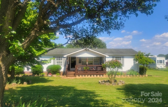 rear view of property with a yard and covered porch