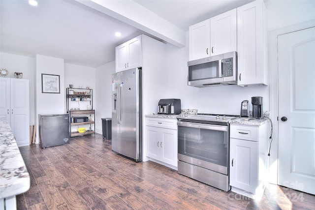 kitchen with white cabinetry, stainless steel appliances, and light stone counters