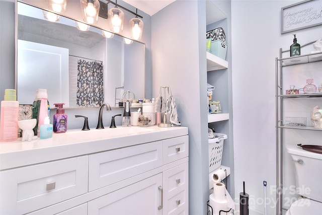 bathroom featuring vanity, toilet, and walk in shower