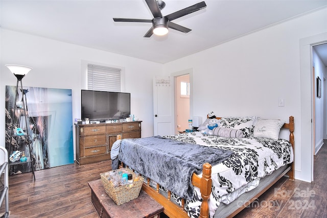 bedroom with dark hardwood / wood-style flooring and ceiling fan