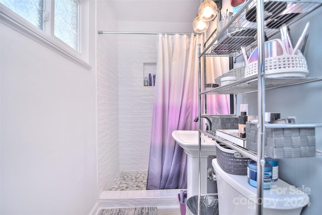 bathroom with a shower with curtain and toilet