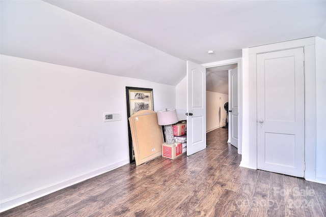 bonus room with vaulted ceiling and dark hardwood / wood-style floors