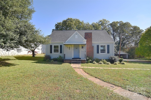 bungalow-style home featuring a front lawn