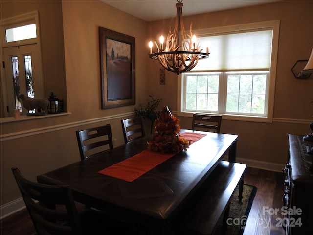 dining room featuring dark wood-type flooring and a chandelier