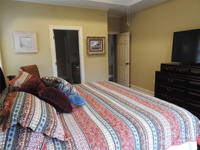 bedroom featuring ensuite bath and crown molding