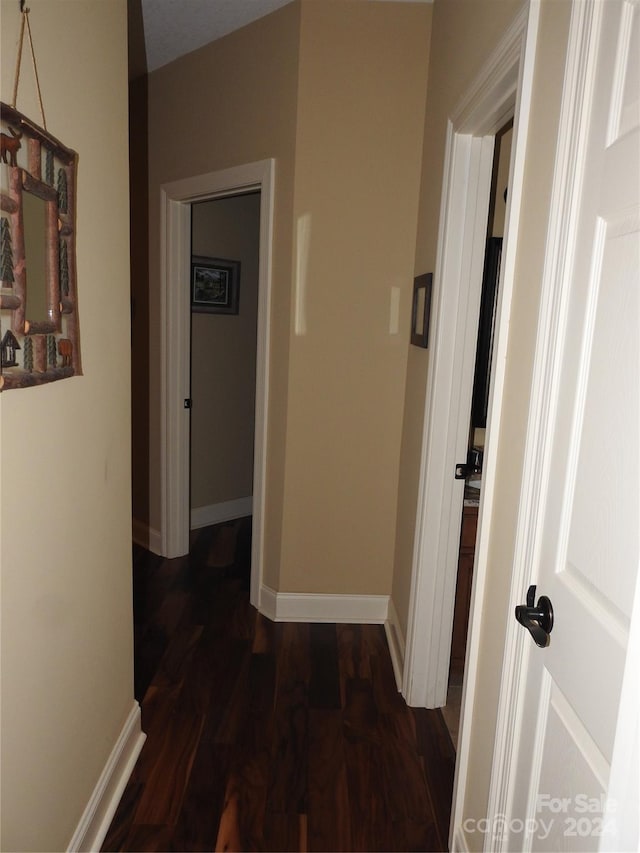 hallway with dark hardwood / wood-style flooring