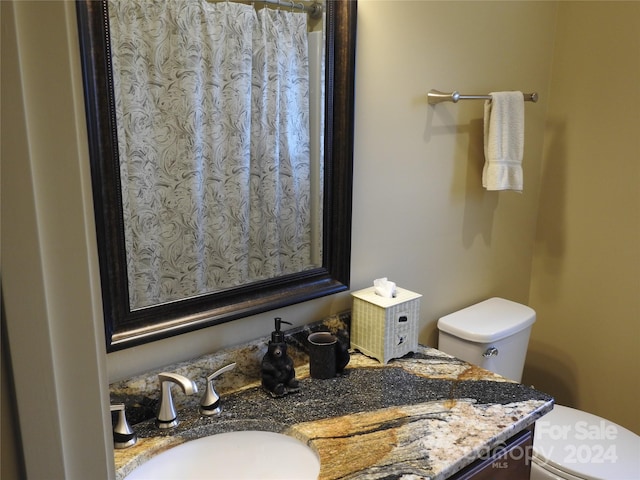 bathroom featuring vanity and toilet