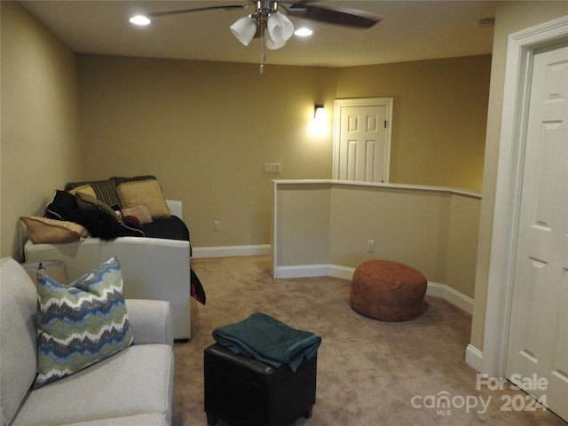 carpeted living room featuring ceiling fan