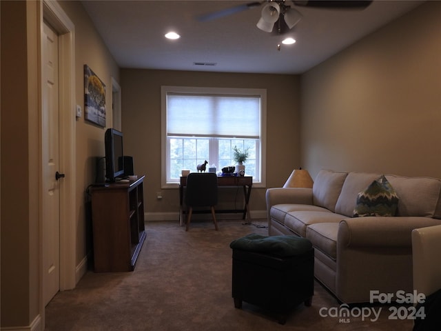 carpeted living room featuring ceiling fan