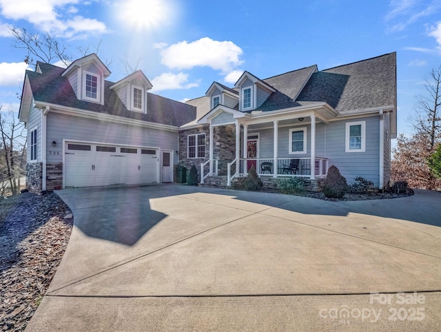 view of front of home featuring a porch and a garage