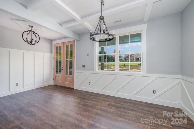 unfurnished dining area featuring beam ceiling, dark wood-type flooring, a notable chandelier, french doors, and coffered ceiling