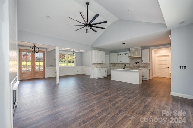 unfurnished living room featuring dark hardwood / wood-style floors, sink, high vaulted ceiling, and ceiling fan