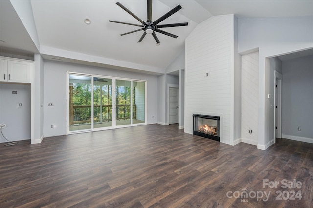 unfurnished living room featuring high vaulted ceiling, a large fireplace, dark wood-type flooring, and ceiling fan