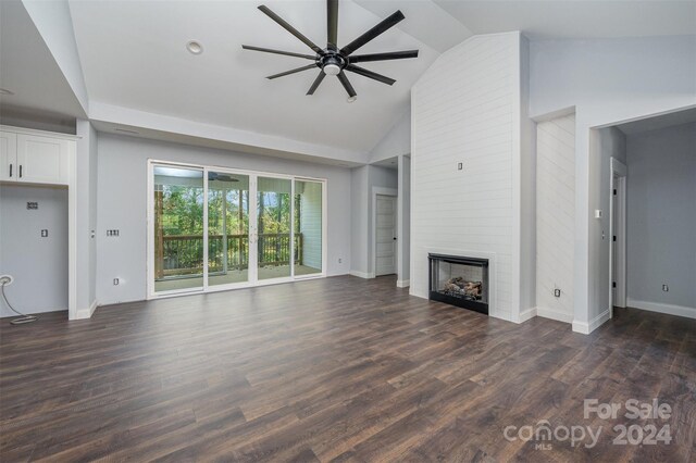 unfurnished living room featuring a large fireplace, high vaulted ceiling, dark hardwood / wood-style floors, and ceiling fan