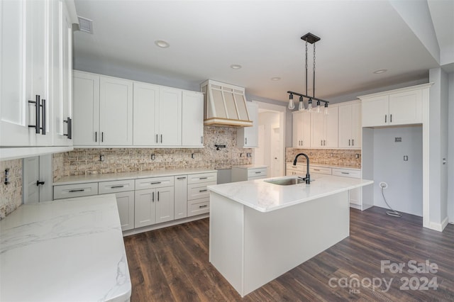 kitchen featuring white cabinets, sink, decorative light fixtures, and dark hardwood / wood-style flooring