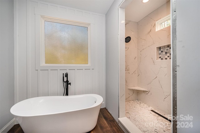 bathroom with separate shower and tub and hardwood / wood-style floors