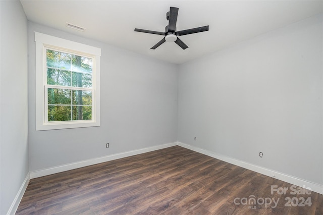 unfurnished room featuring dark wood-type flooring and ceiling fan