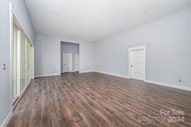 unfurnished room with dark wood-type flooring