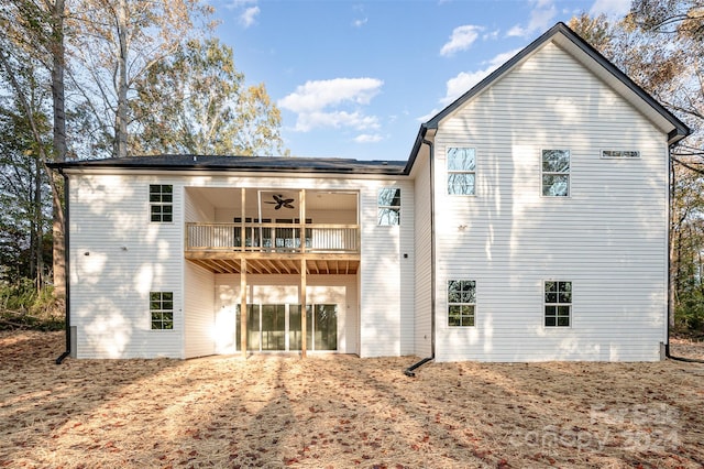 back of house with a balcony and ceiling fan