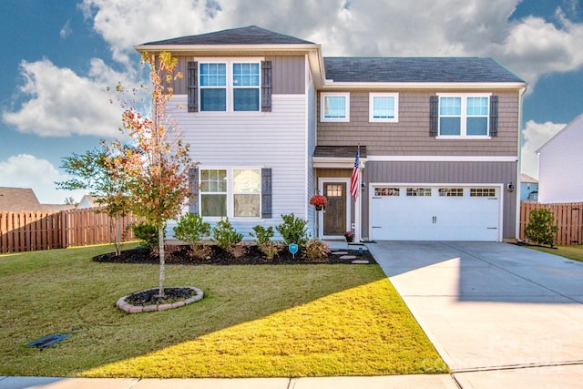 view of front of house with a front yard and a garage