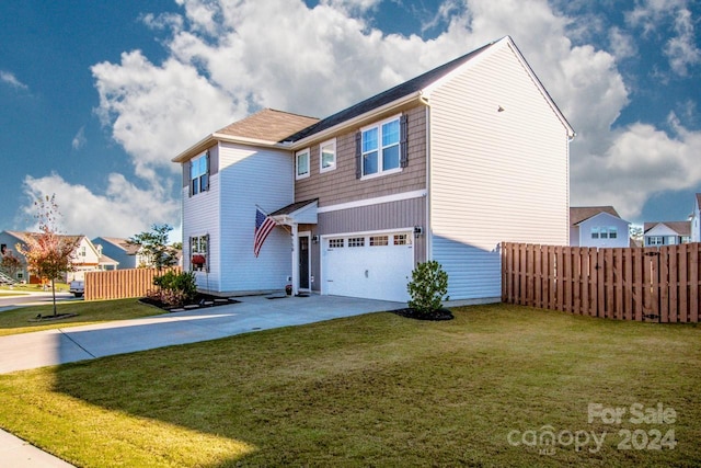 view of front of home featuring a front yard and a garage