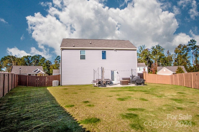 back of property featuring a yard, a patio, and an outdoor fire pit