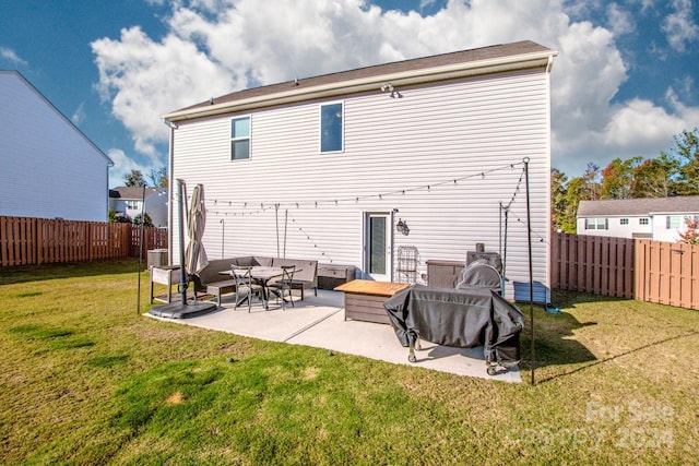 back of house featuring a yard and a patio