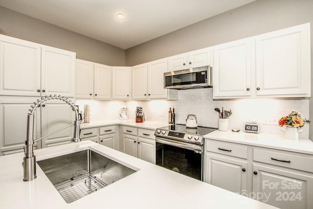 kitchen featuring white cabinetry, appliances with stainless steel finishes, and sink