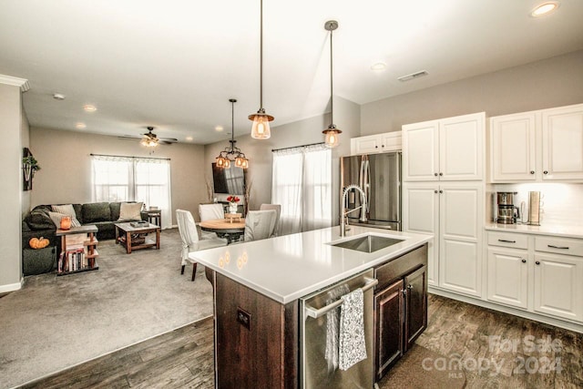 kitchen with appliances with stainless steel finishes, sink, dark hardwood / wood-style flooring, white cabinetry, and ceiling fan