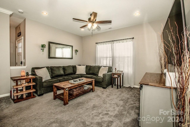 carpeted living room with ceiling fan