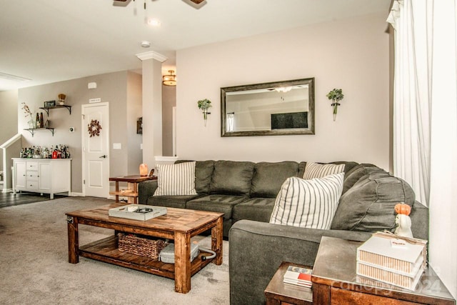 carpeted living room with ornate columns and ceiling fan