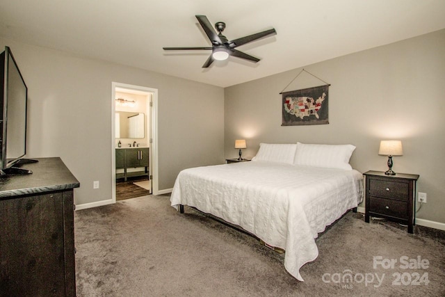 carpeted bedroom with ensuite bathroom, sink, and ceiling fan