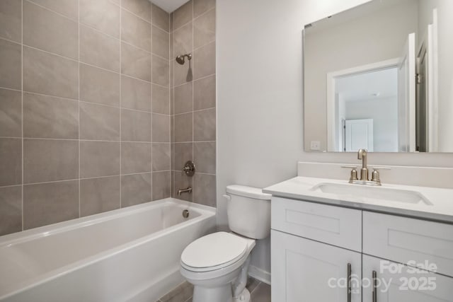 full bathroom with tiled shower / bath combo, toilet, and vanity