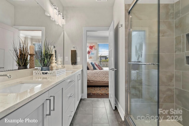 ensuite bathroom featuring a sink, double vanity, ensuite bathroom, and a shower stall