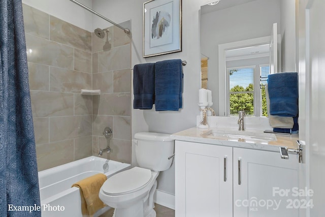 bathroom featuring vanity, toilet, baseboards, and shower / tub combo