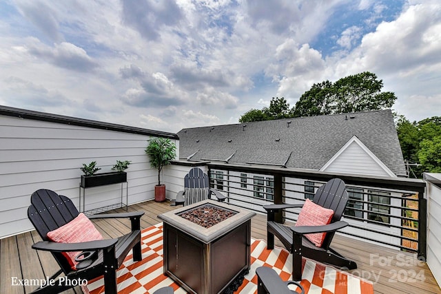 wooden deck featuring a fire pit