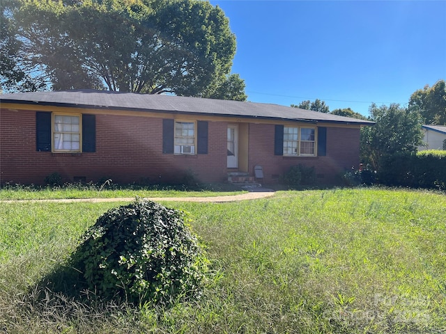 ranch-style home featuring crawl space, a front lawn, cooling unit, and brick siding