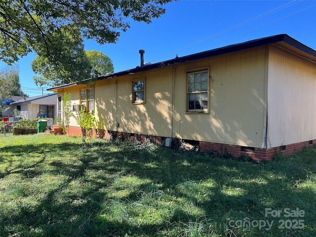 view of home's exterior featuring crawl space and a lawn