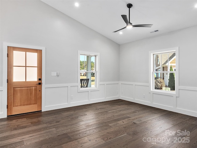 interior space with plenty of natural light, dark hardwood / wood-style floors, and lofted ceiling