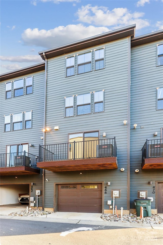 back of property featuring a garage and a balcony