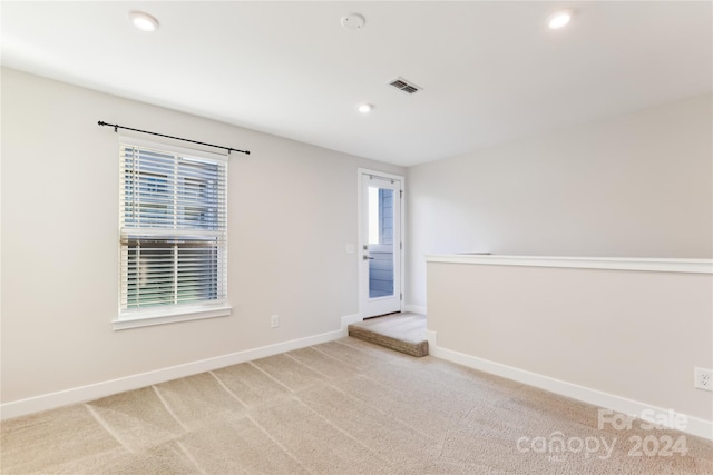 unfurnished room with light carpet