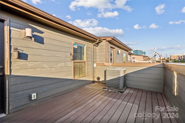 wooden deck featuring central air condition unit