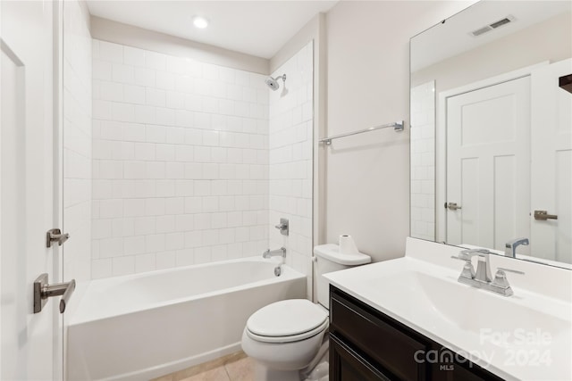 full bathroom with toilet, tiled shower / bath combo, vanity, and tile patterned flooring